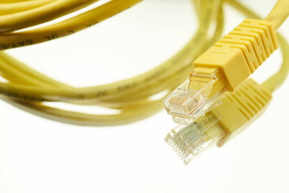 Dense network cabling running through a data centre rack